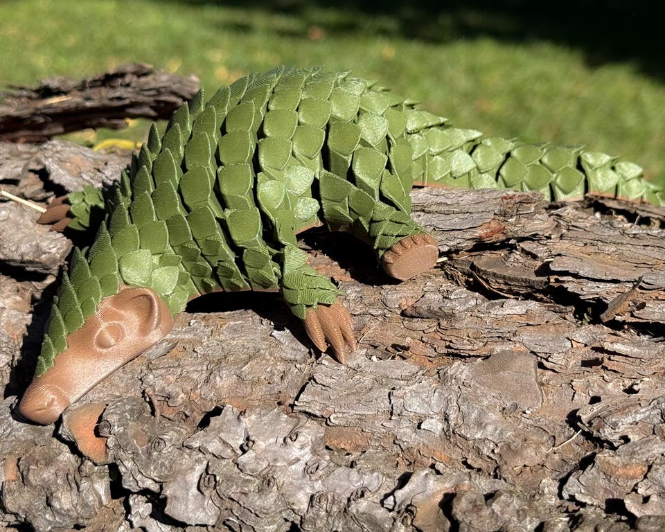 Green and Brown Let's Live Pangolin Toy on Log