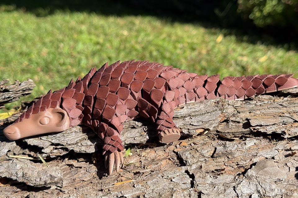 Rose Wood Let's Live Pangolin Toy on Log