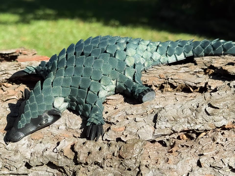 Green 3D printed Let's Live Pangolin Toy on Log