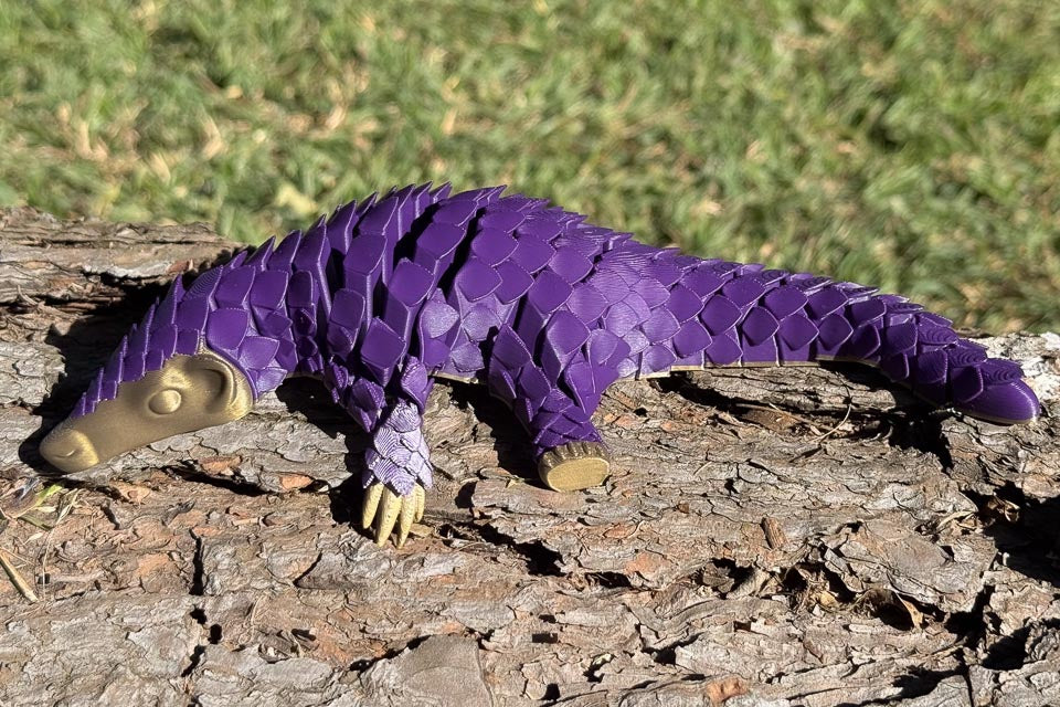 Purple Let's Live Plastic Pangolin Toy on Log