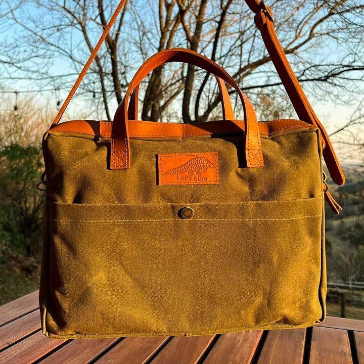 Green canvas and Brown leather laptop bag with Let's live Pangolin logo