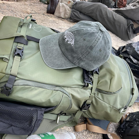 Lets Live Pangolin Cap on Backpack while on hike in Kruger Park
