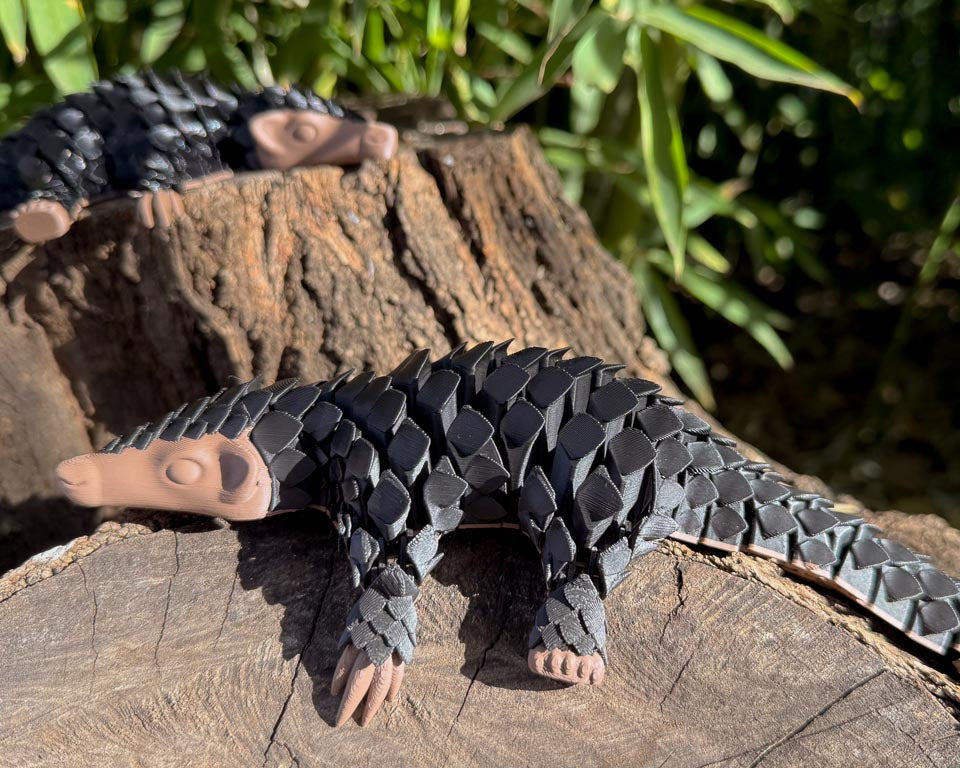 Black Let's Live Pangolin 3D plastic Toy on Log