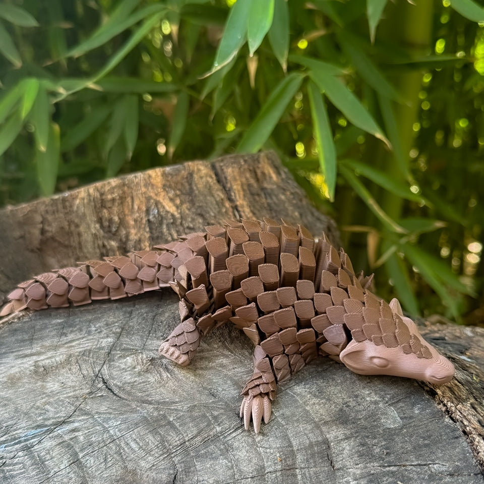 Brown Pangolin Toy on a wooden log