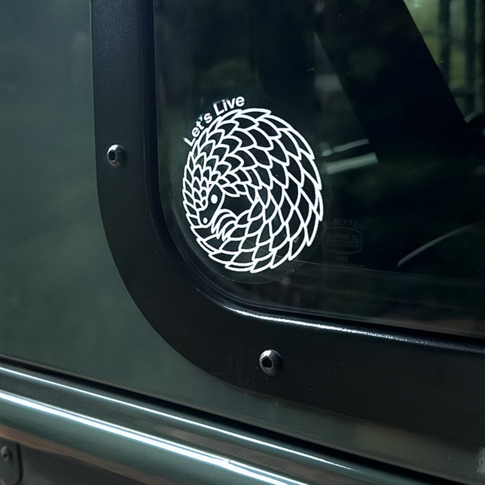 Ball Pangolin Decal Sticker on a Car Window with 'Let's Live' text