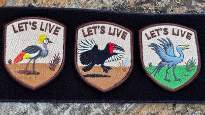 Three embroidered let's live badges with South African Ground hornbill, blue crane and grey crowned crane