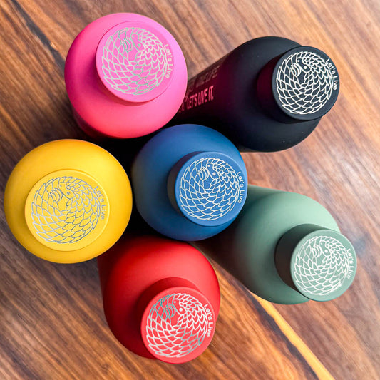Set of colourful bottles with curled up pangolins engraved on the lids, with "Let's Live" text