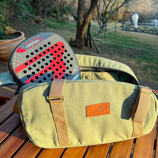 Green padel bag with a paddle showing inside lining