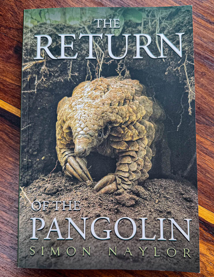 Pangolin on the cover of a book called The return of the pangolin by Simon Naylor