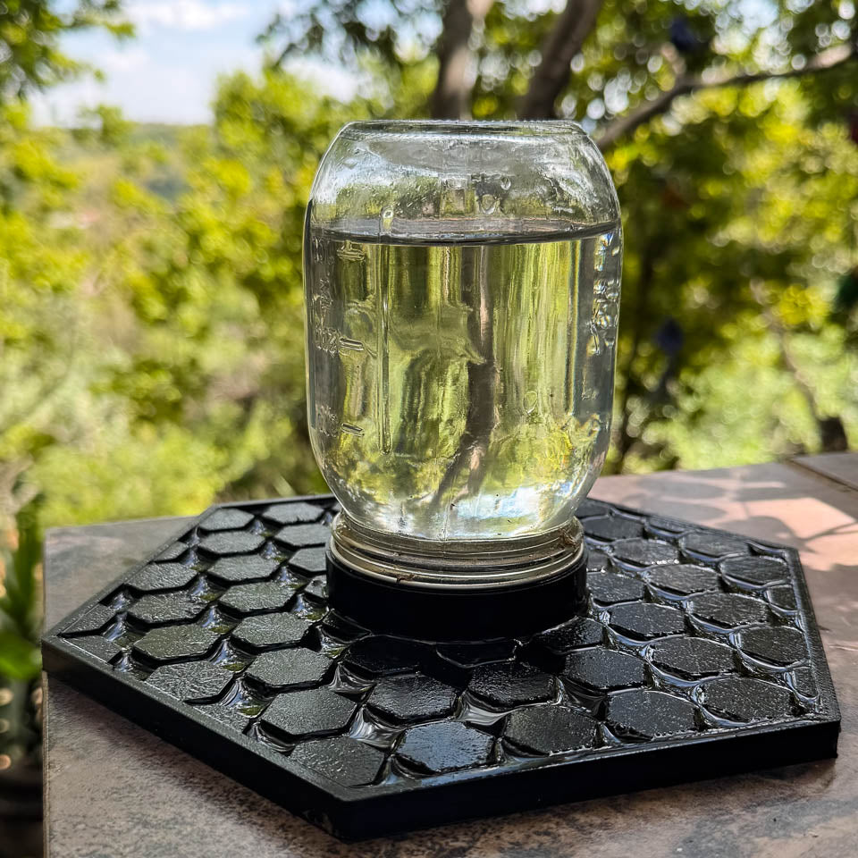 Mason jar with water on top of bee water dispensing tray